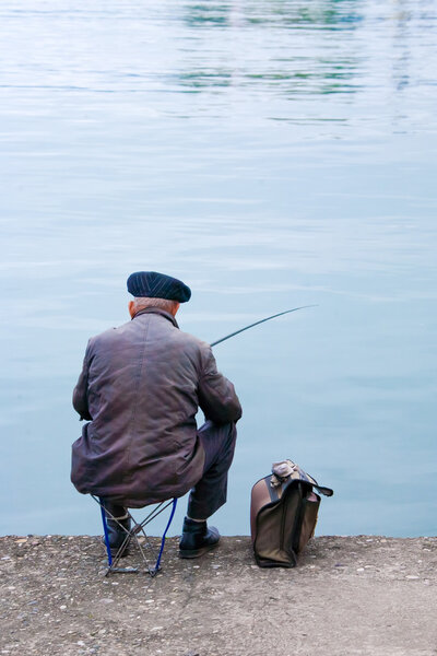 Old fisherman sitting