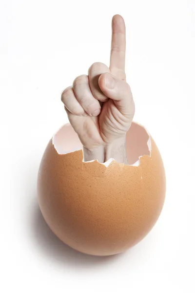 Finger in the eggshell on white — Stock Photo, Image