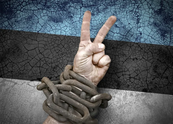 Hand victory sign in chains — Stock Photo, Image