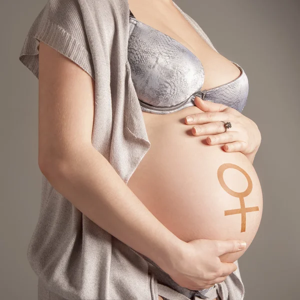 Gravid kvinna med kvinnlig symbol — Stockfoto