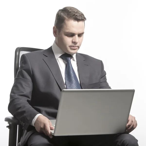 Man in a jacket holding laptop — Stock Photo, Image