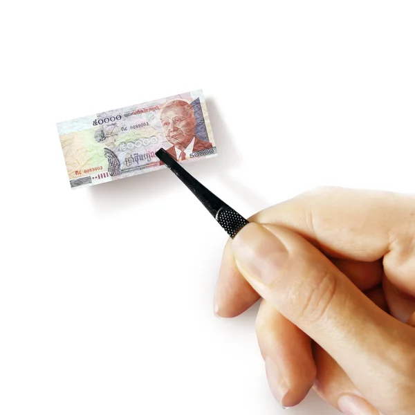 Hand with a pincet holding small banknote — Stock Photo, Image