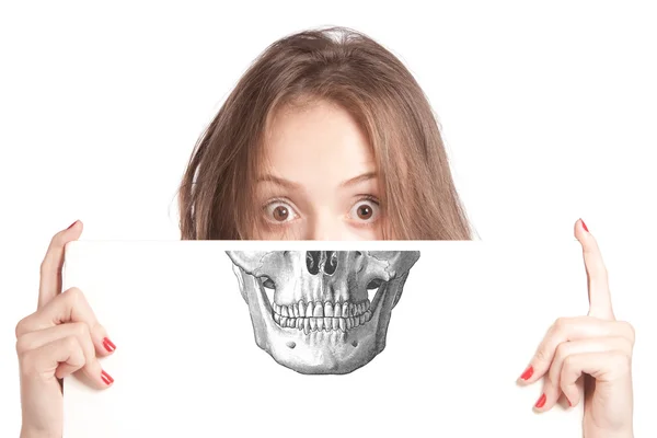 Woman holding a  skull  on a face — Stock Photo, Image