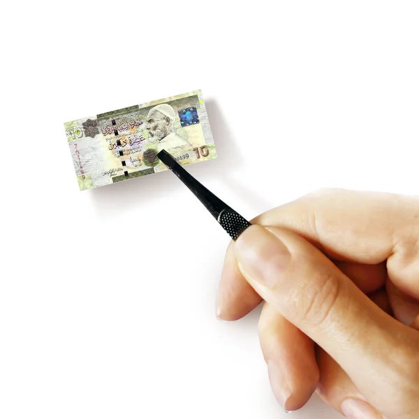 Hand with a pincet holding small banknote — Stock Photo, Image