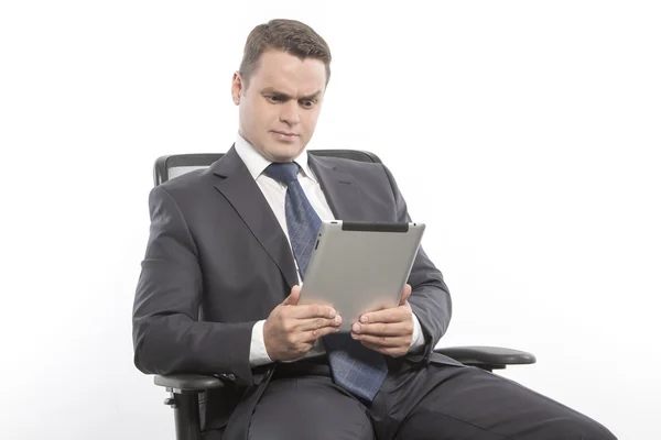 Man in a jacket sitting on a chair — Stock Photo, Image