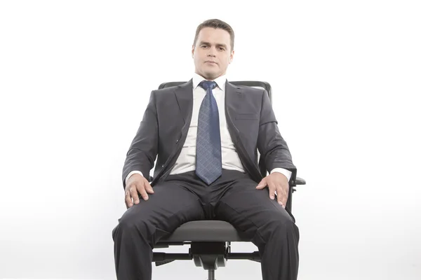 Man in a jacket sitting on a chair — Stock Photo, Image