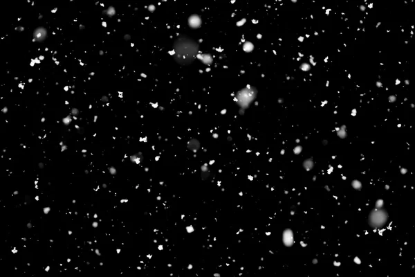 Снегопад на черном фоне — стоковое фото