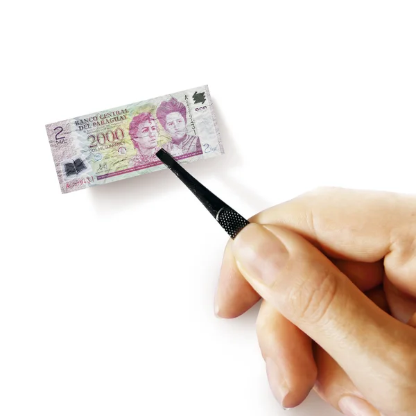 Küçük banknot tutan bir pincet ile el — Stok fotoğraf