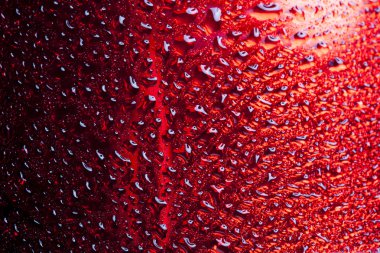 Water drops on red metal surface