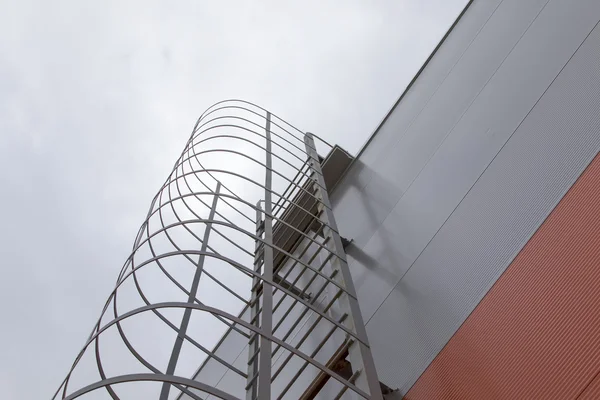 Metal fire escape ladder on wall — Stock Photo, Image