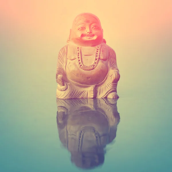 Buddha statue on blue surface — Stock Photo, Image