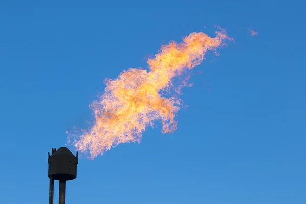 Black gas pipe with fire flames — Zdjęcie stockowe