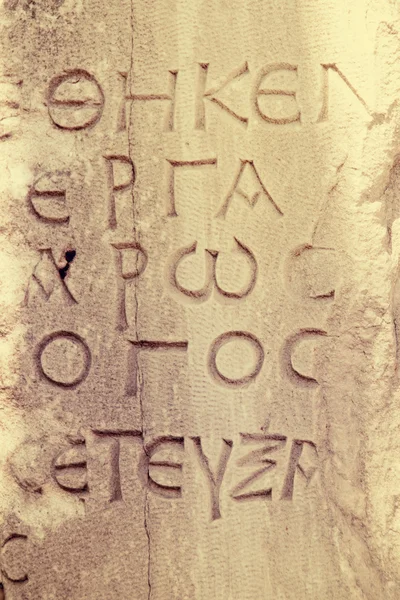 Ancient letters carved in stone — Stock Photo, Image