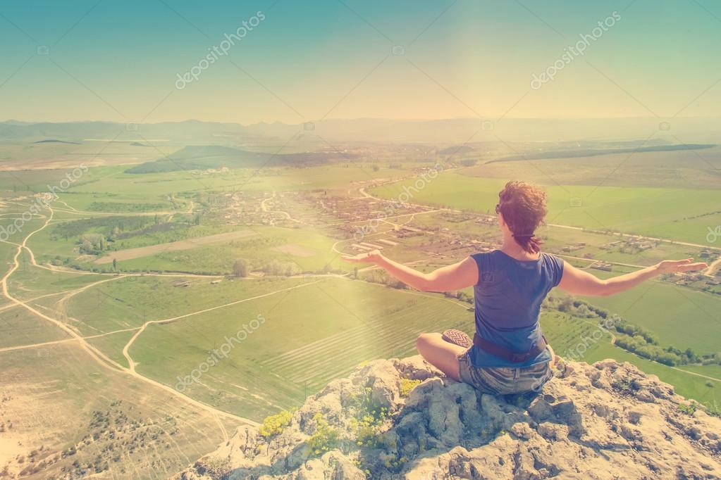 Young woman posing on top of  mountain