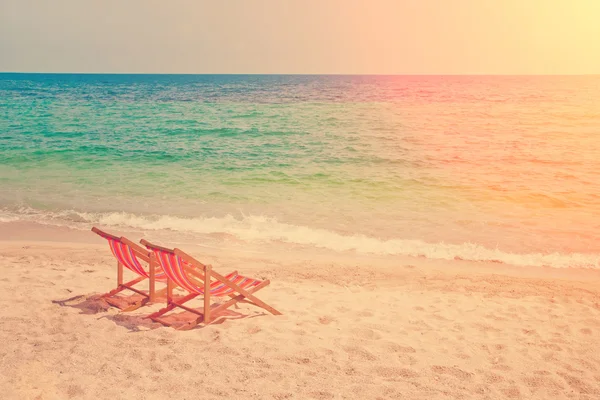 Lounge chairs on sandy beach — Stock Photo, Image