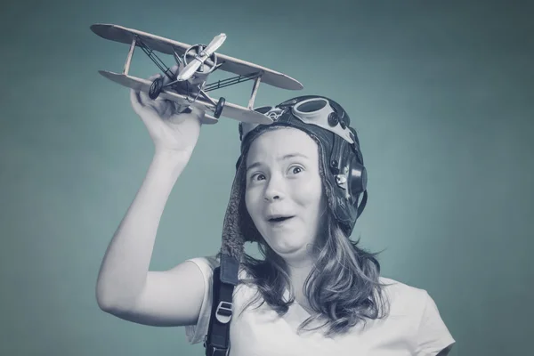 Cute girl playing with airplane model — Stock Photo, Image