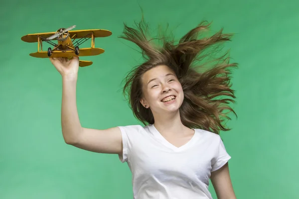 Cute girl playing with airplane model — Stock Photo, Image