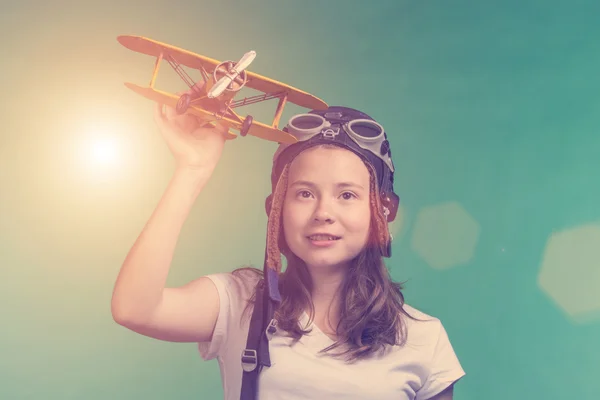 Cute girl playing with airplane model — Stock Photo, Image