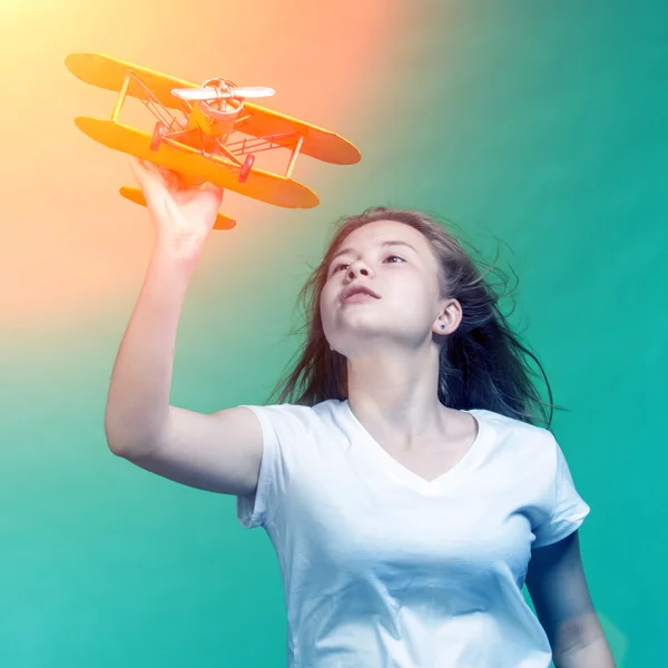 Cute girl playing with airplane model — Stock Photo, Image