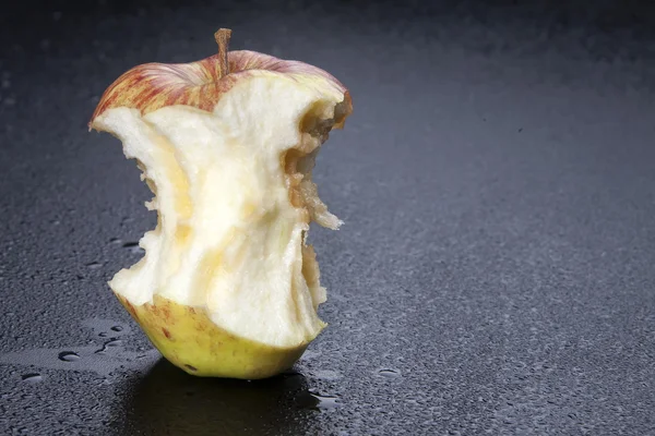 Apple core on dark background — Stock Photo, Image