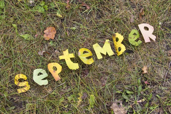 Слово Сентябрь вырезано из листьев — стоковое фото