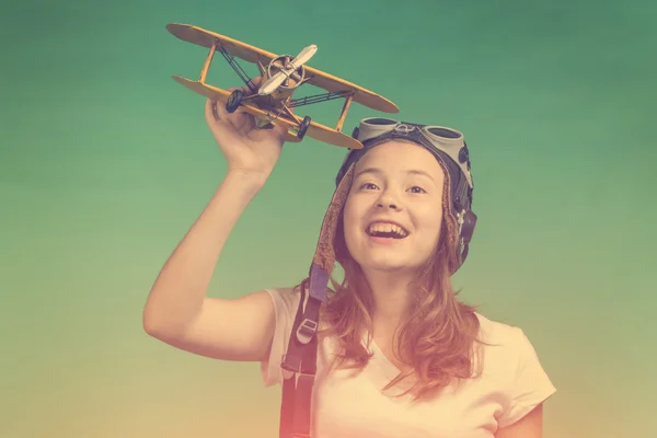 Cute girl playing with airplane model — Stock Photo, Image