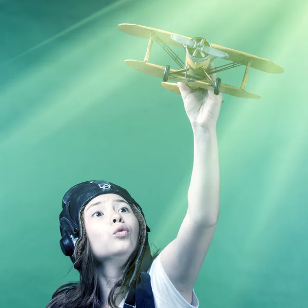 Cute young girl with airplane model — Stock Photo, Image