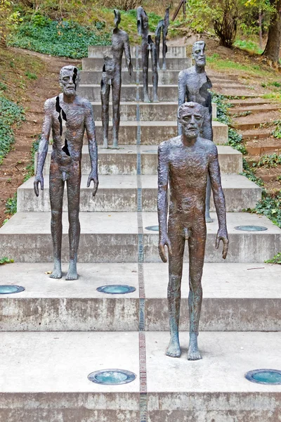 Metal men with cracks on the stairs. — Stock Photo, Image