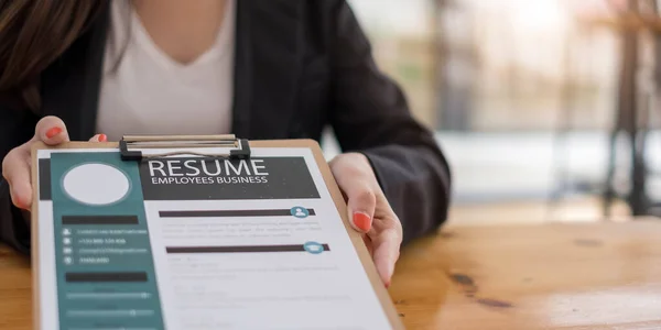 Businesswoman submits resume employer to review job application information on the desk, presents the ability for the company to agree with the position of the job