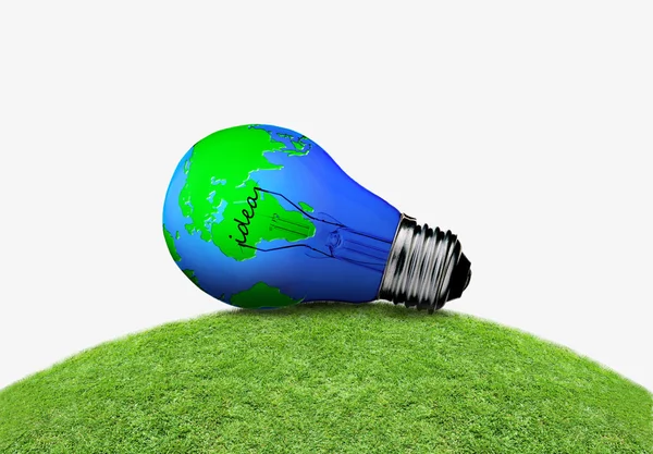 Incandescent bulb on a green meadow — Stock Photo, Image