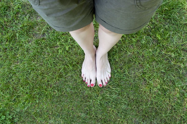 Nackte Füße im Gras Hintergrund. — Stockfoto