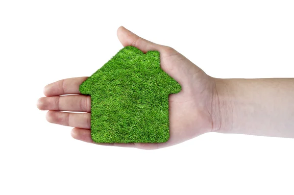 Green grass home icon in his hand — Stock Photo, Image