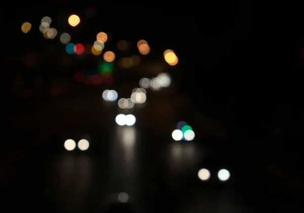 Blurred, bokeh in road, dark night. Beautiful blurry abstract background.