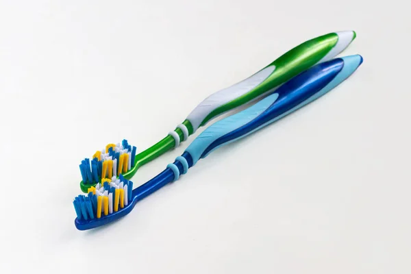 Two New Toothbrushes Green Blue Multi Colored Bristles Light Background — Stock Photo, Image