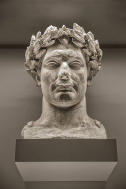 Paris, France, 08.23.2017. A man's head with a Laurel wreath is a fragment of an antique marble statue from the Museum collection
