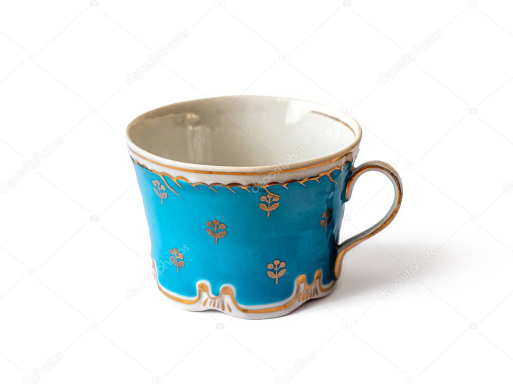 Vintage blue porcelain cup with handle and fine gold pattern, isolated on white background