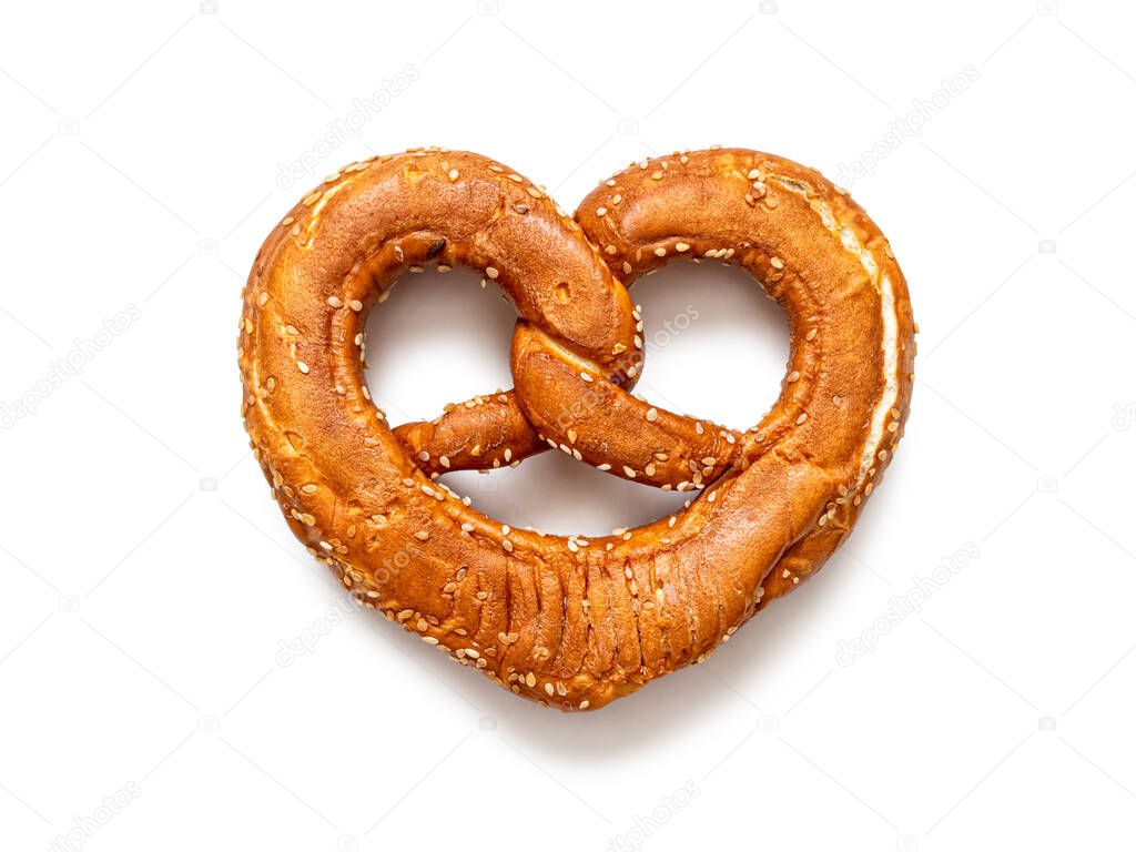 Brezel - German pretzel sprinkled with sesame seeds, common in southern Germany, isolated on a white background