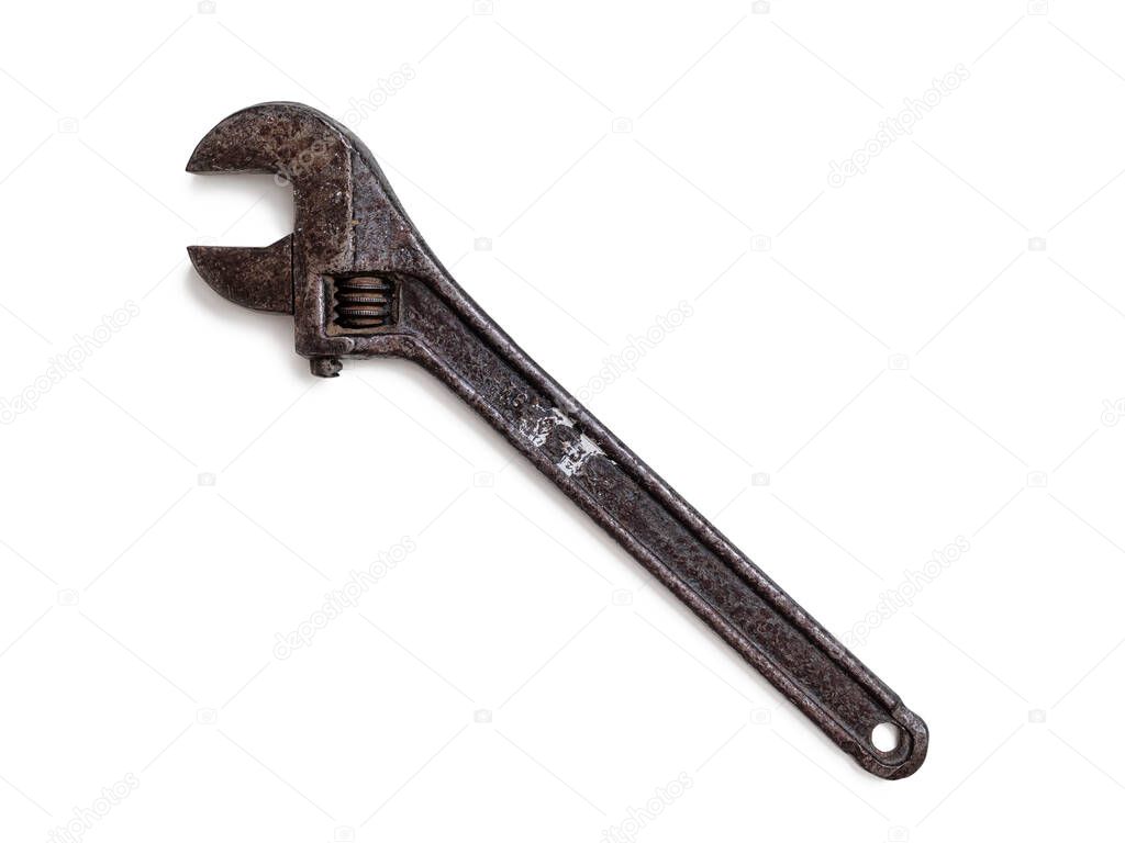 An old rusty wrench. Variable-size wrench used to Rotate nuts, bolts, and other parts, isolated on a white background
