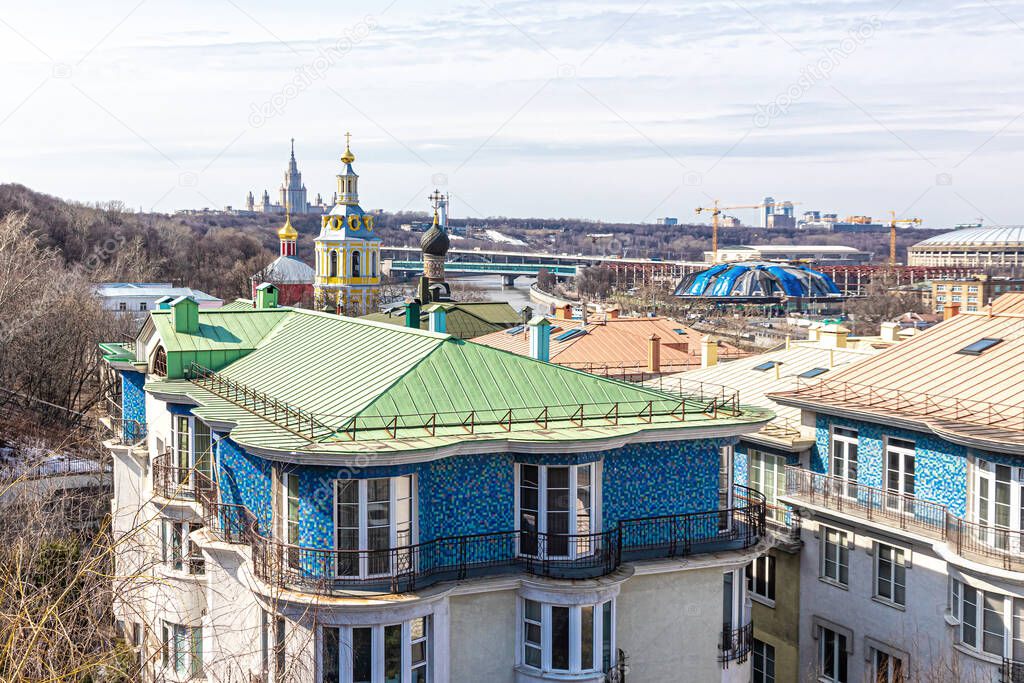 Moscow, Russia, 04.06.2021. View of the Vorobyovy Gory, the domes of the St. Andrew's Monastery, the Moscow State University and the roofs of residential buildings on the St. Andrew's Embankment
