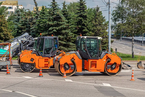 Two road asphalt rinks, orange color for laying asphalt. Road equipment for road repairs