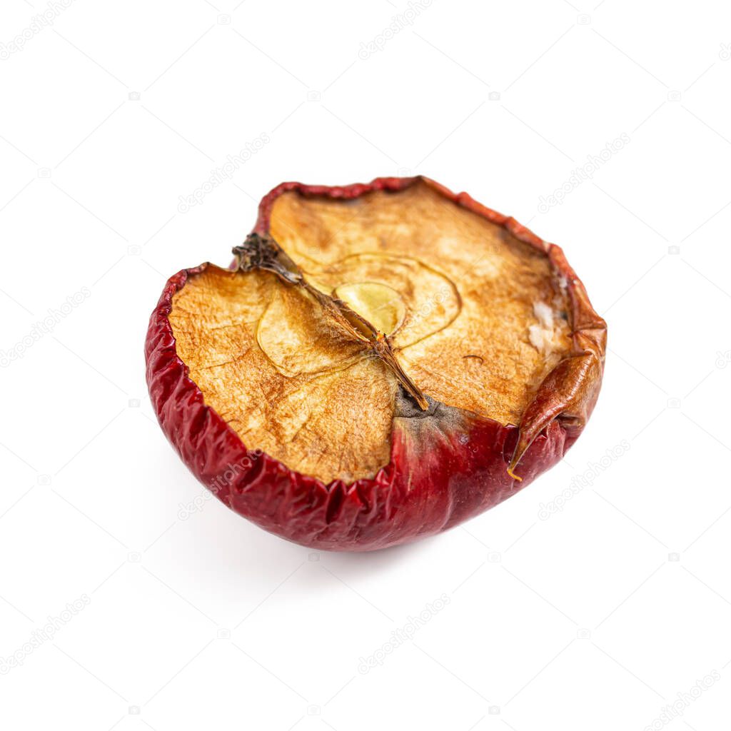 An apple core. An old dried apple, cut in half on a white background