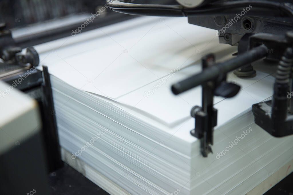 Stack of paper in a printing press.