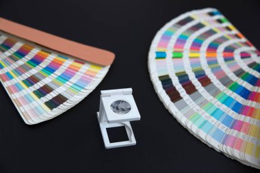 Renk yönetimine basın. Siyah arkaplanda Cmyk çizgili loupe ve renk paleti.