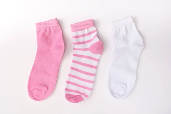 Three socks in pink color gamma, laying from white to pink close up on white background — Stock Photo, Image