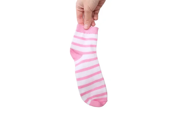 Ένα χέρι κρατώντας ένα ροζ και λευκό ριγέ βαμβάκι οργανική κάλτσα απομονώνονται σε λευκό — Φωτογραφία Αρχείου