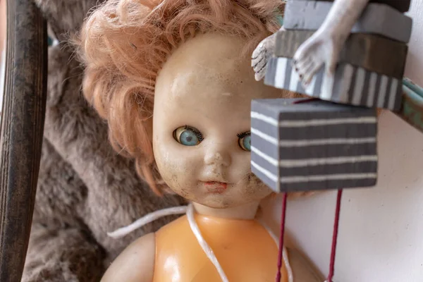 En gammel, slitt dukke med skittent ansikt i nærheten, skummel utsikt – stockfoto