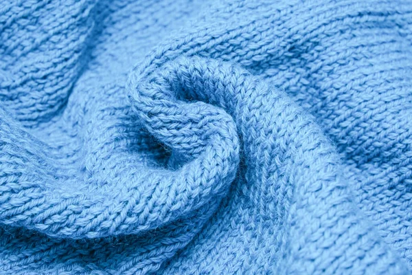 Crumpled knitted blue fabric background, waved and twisted, curved turquoise woolen knitwear — Stock Photo, Image