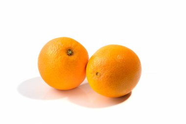 Two ripe oranges on a white isolated background, shadow.