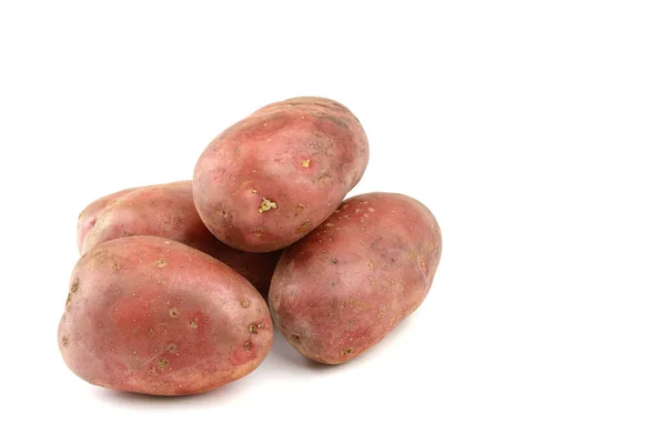 Raw pink potato tubers on a white isolated background.Potatoes in the skin. — Stock Photo, Image