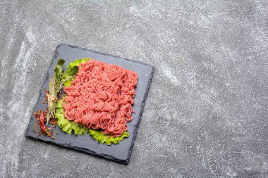 Sarımsak, kırmızı biber ve dereotla süslenmiş taze kıyma ve domuz eti. Koyu doku arka planı. Düz plan..